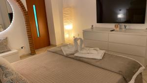 Ένα ή περισσότερα κρεβάτια σε δωμάτιο στο La Dimora