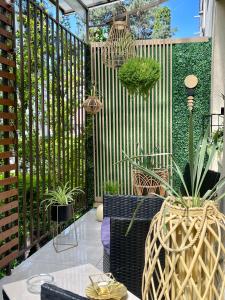 a patio with potted plants and a fence at Maya Apartment in Cluj-Napoca