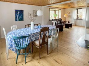 a dining room with a table and chairs and a living room at Farmhouse Retreat Near Lakes and Coast in Högsby
