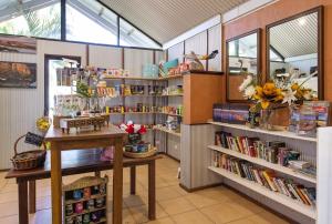 a book store with a table and shelves of books at Discovery Parks - Lake Kununurra in Kununurra