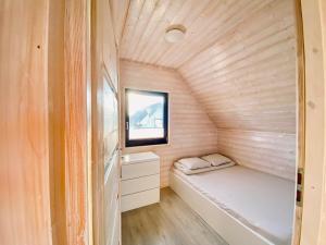 a small room with a bed in a tiny house at SAND Sarbinowo in Sarbinowo