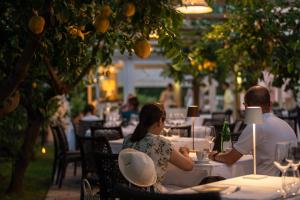 a man and woman sitting at a table in a restaurant at Boutique Hotel Casa Mariantonia in Anacapri