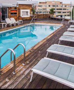 a large swimming pool with lounge chairs on a building at Heart of the French Quarters in New Orleans