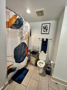 a bathroom with a toilet and a shower curtain at Heart of the French Quarters in New Orleans