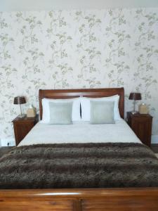 a bedroom with a large bed with two night stands at The Harbour in Evenjobb