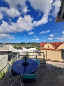 a patio with a blue table and chairs on a balcony at Isaias house in Rhodes Town