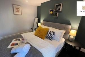 a small bedroom with a bed with yellow pillows at Central Three Bedroom Flat I Sleep Up to 9 Guests in Brighton & Hove