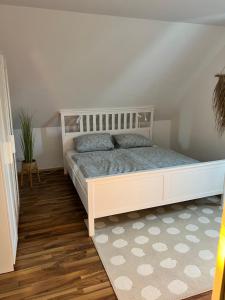 a bedroom with a white bed in a room at Ferienvermietung Schneider in Wiehl