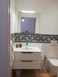 a bathroom with a sink and a mirror and a toilet at Apartment/Studio il Girasole in Rapallo +37 photos
