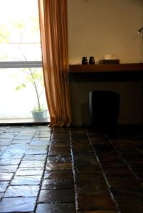 a room with a window and a stone floor at Howcome spots homestay in Hualien City