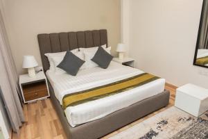 a bedroom with a large bed with two night stands at Hiyala home in Male City