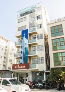 a tall building with motorcycles parked in front of it at Hiyala home in Male City