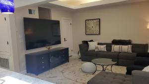 a living room with a couch and a flat screen tv at Beautiful Home 4 Bd. 2 Ba. SF. in San Francisco