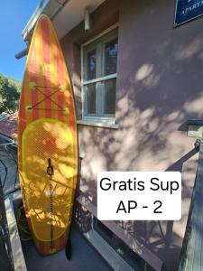 a surfboard is leaned up against a building at Anita Prižba in Prizba