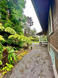 a porch of a house with a bench next to it at Volcano Hideaway Cabin as seen on HGTV in Volcano