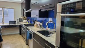 a kitchen with a sink and a microwave at Beautiful Home 4 Bd. 2 Ba. SF. in San Francisco