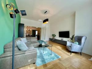 a living room with a couch and a tv at Luxury Apartment in Old Town in Prague