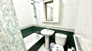 a bathroom with a sink and a toilet and a bath tub at Menendez Bohemian Dreams by Deihu Experiences in Los Cristianos +14 photos