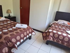 Postel nebo postele na pokoji v ubytování Hotel Residencial C´BASTIAN