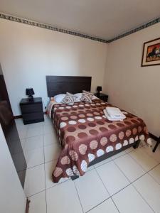 Postel nebo postele na pokoji v ubytování Hotel Residencial C´BASTIAN