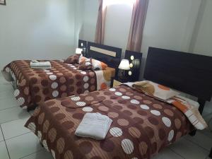 Postel nebo postele na pokoji v ubytování Hotel Residencial C´BASTIAN