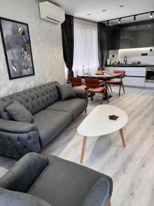 a living room with a couch and a table at Premium Suites in Stara Zagora
