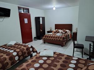 Postel nebo postele na pokoji v ubytování Hotel Residencial C´BASTIAN