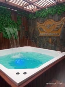 a jacuzzi tub with a water fountain in it at Casa Iris Hotel Boutique in Barichara