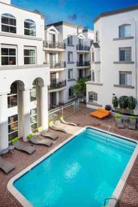 a large swimming pool in front of a building at Tulip - 2 bedroom apartment in West Hollywood in Los Angeles