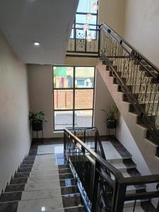 a spiral staircase in a house with a window at FourPoints Lodge in Lilongwe