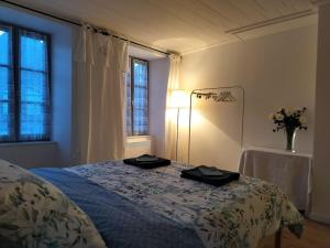 a bedroom with a bed with two towels on it at La Ramure, maison de village in Allanche +5 photos