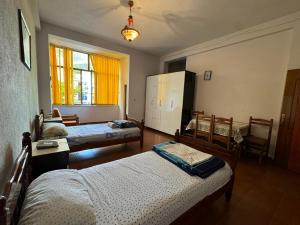 a bedroom with two beds and a window at Hotel brazil in Peshkopi