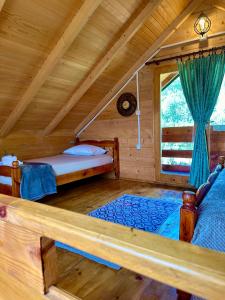 a bedroom with two beds in a log cabin at Green Heaven Cottage in Ulcinj