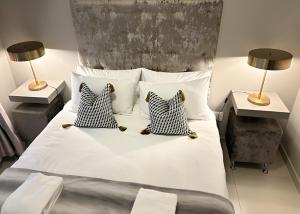 um quarto com uma cama grande e 2 candeeiros em Meerendahl @ Heritage Square em Durbanville