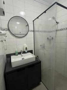 a bathroom with a sink and a glass shower at RUBIS SUITE in Mostar
