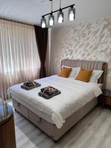 a bedroom with a bed with two towels on it at Premium Suites in Stara Zagora