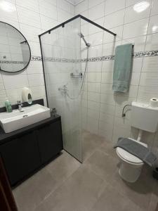 a bathroom with a shower and a sink and a toilet at RUBIS SUITE in Mostar