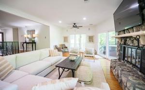 a living room with a white couch and a fireplace at CHLChateau-Walkable to Hurricane Marina in Silver Point