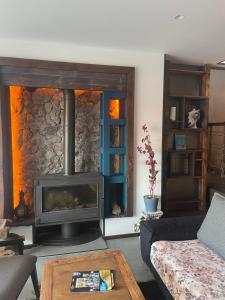 a living room with a fireplace and a couch at Havuzlu ve jakuzili full eşyalı lüks villa in Bodrum City
