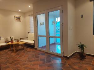 a living room with a sliding glass door at Hotel San Cristobal in San Cristóbal