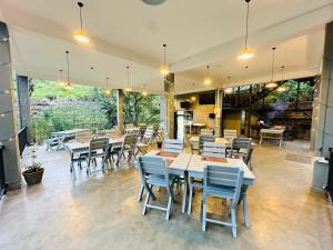 a restaurant with tables and chairs in a room at Kithal Ella Station Resort in Ella