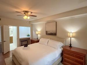 a bedroom with a white bed and a ceiling fan at CHLChateau-Walkable to Hurricane Marina in Silver Point