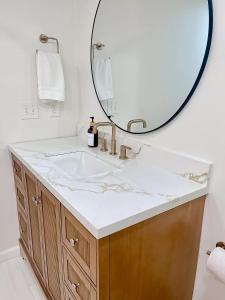 a bathroom with a sink and a mirror at CHLChateau-Walkable to Hurricane Marina in Silver Point +23 photos