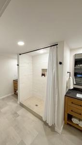 a bathroom with a shower with a glass door at CHLChateau-Walkable to Hurricane Marina in Silver Point
