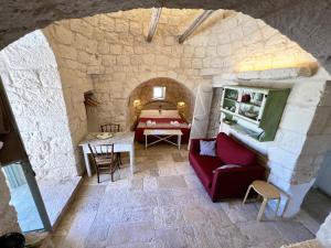 a living room with a couch and a table at Trullo fiore in Ostuni