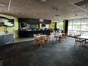 a dining room with tables and chairs in a restaurant at Best Western Little River Inn in Simcoe