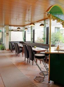 a dining room with tables and chairs in a restaurant at Pension Keinath in Stuttgart +8 photos