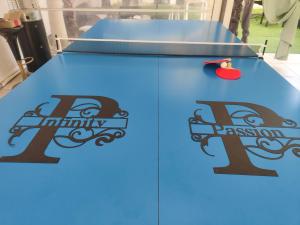 a ping pong table with two signs on it at Infinity Passion in Rho