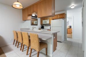 a kitchen with a counter and chairs and a refrigerator at Urban Bungalow WW C301 in New Braunfels