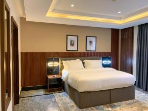 a bedroom with a large bed in a room at Five Homes Hotel and Apartments in Abuja